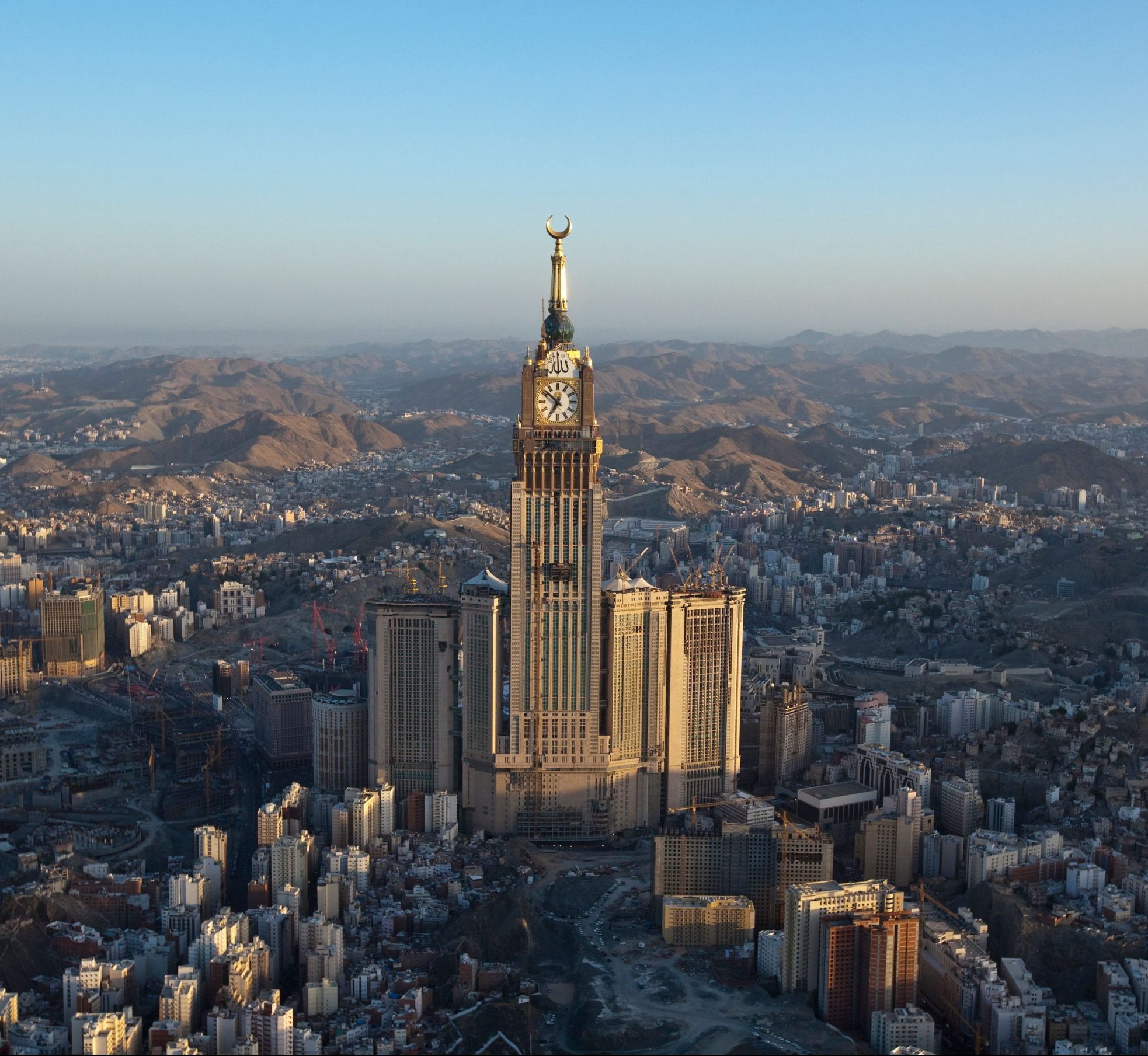 Aerial view of the vibrant urban cityscape of Saudi Arabia, featuring a towering spire.